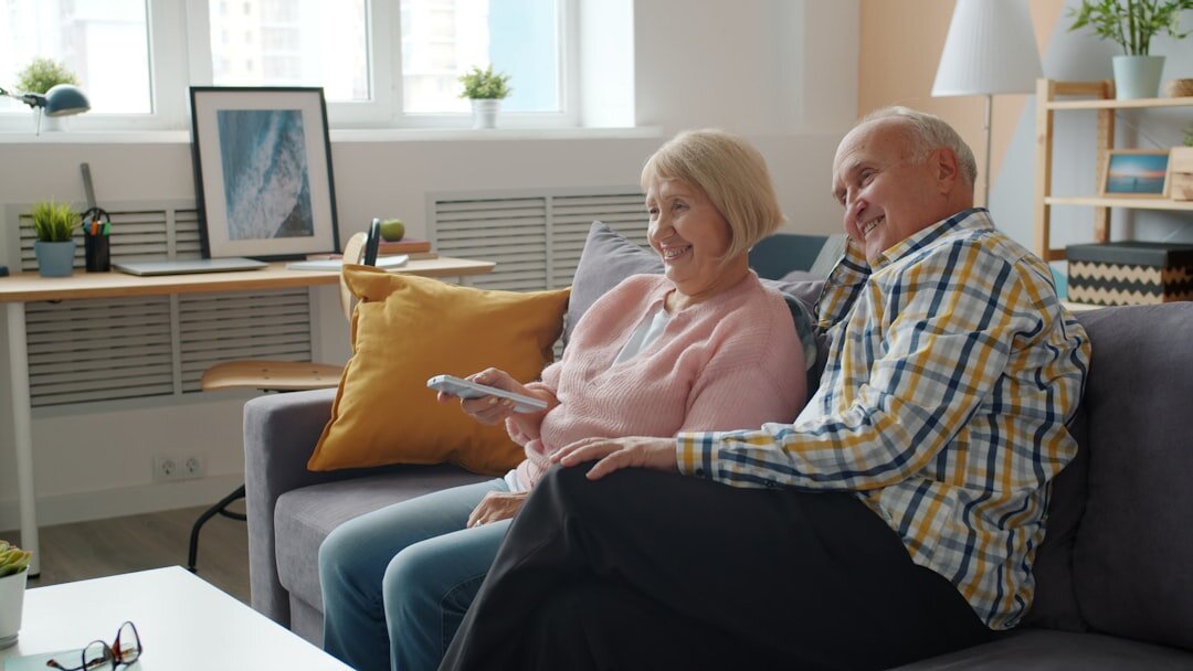 Happy senior couple reviewing a welcome membership package at home