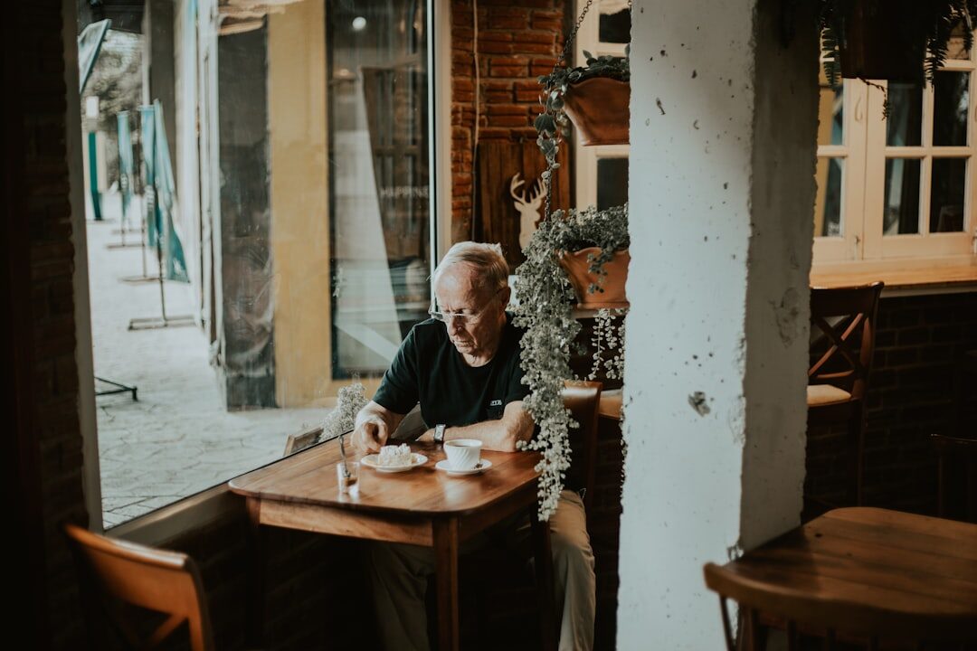 Senior couple enjoying coffee with a discount card at a cafe