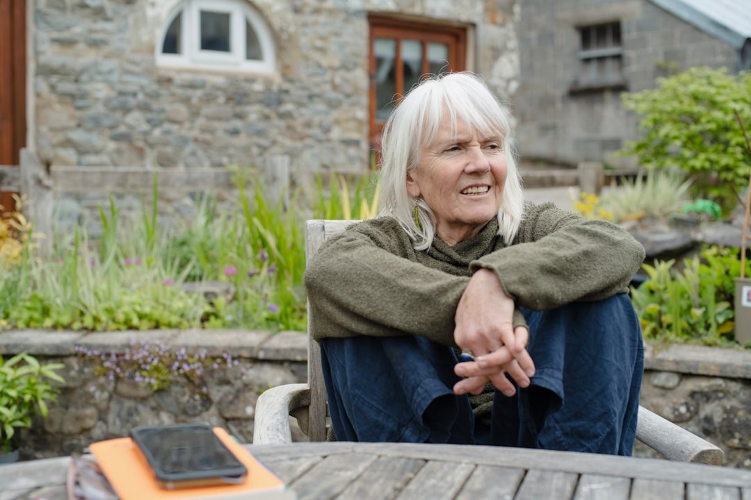 senior woman reading book in garden