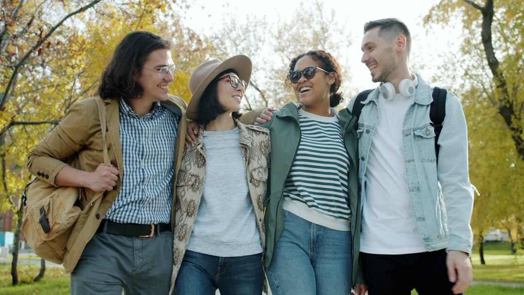 Group of active senior friends laughing together outdoors in a park